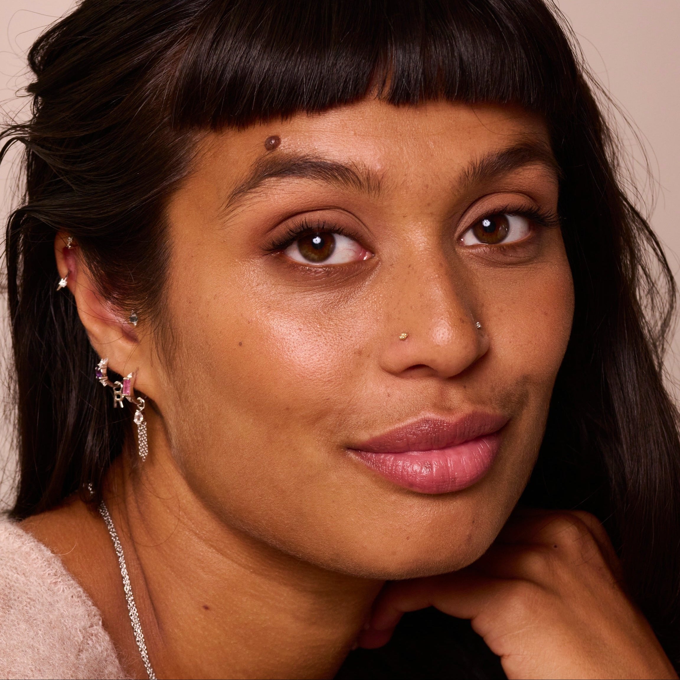 model wearing sterling silver jewellery including the Amethyst & White sapphire Huggie Hoop Earring Sterling Silver