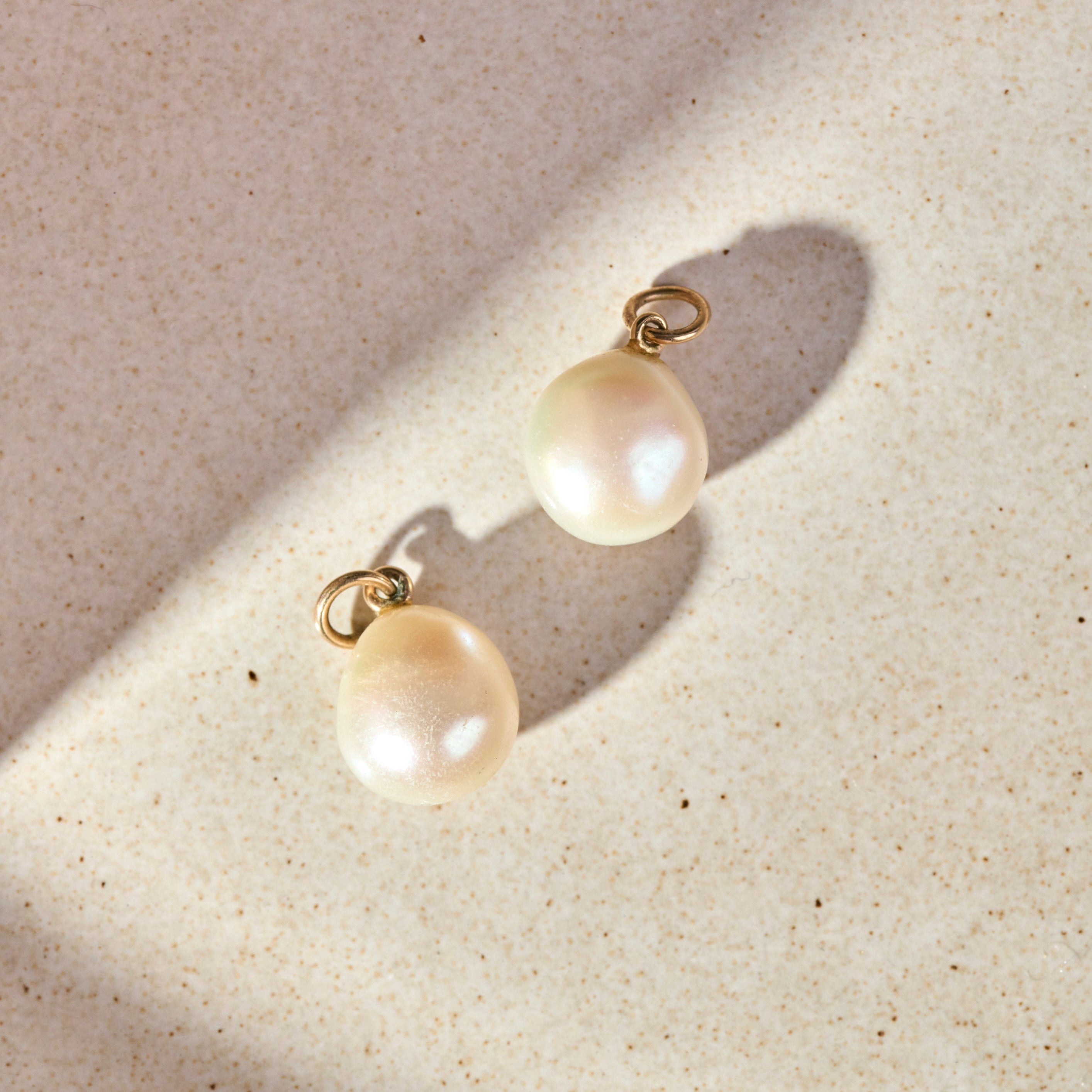 Baroque Pearl Hoop Earrings 9k Gold on marble surface