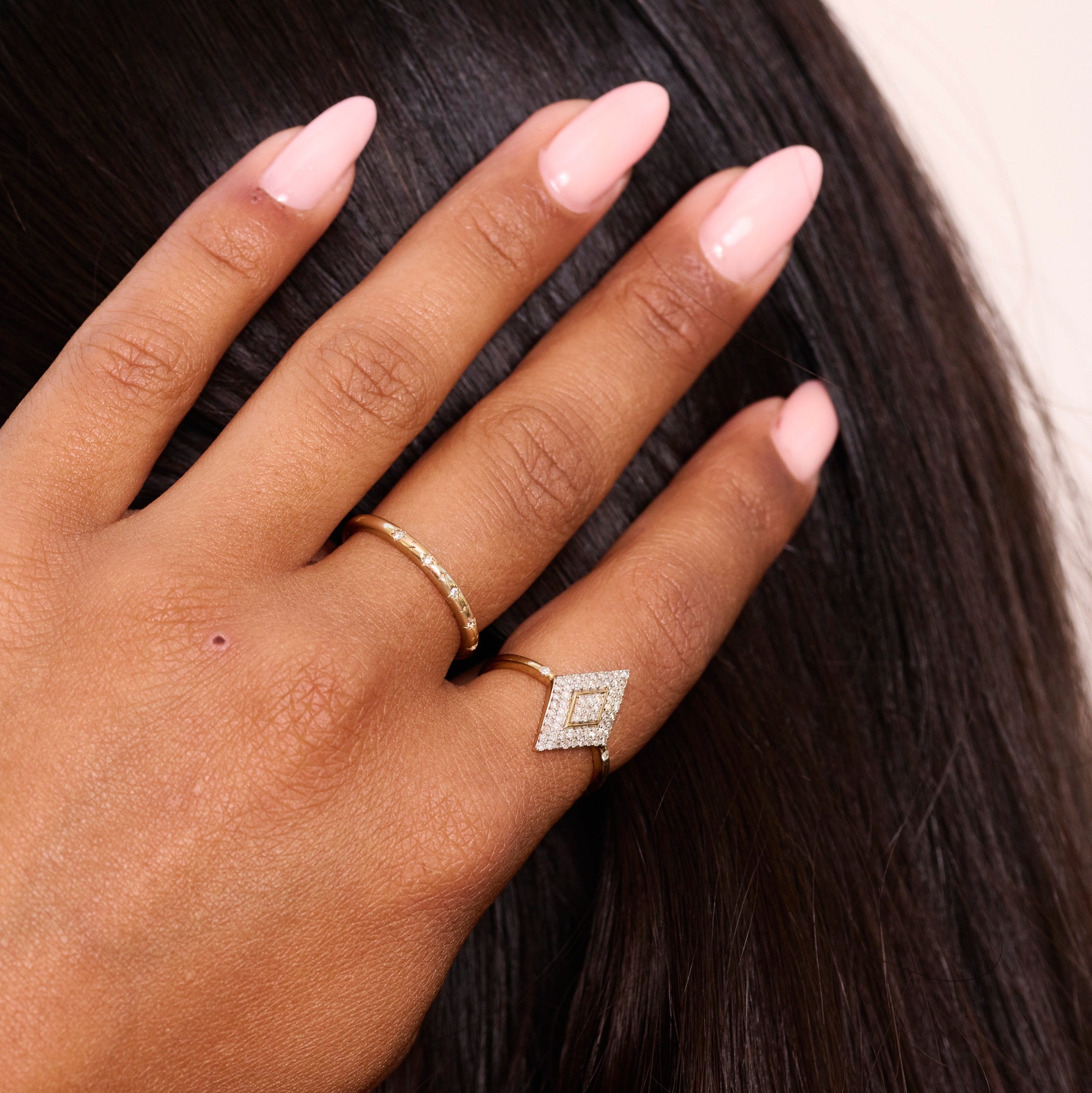 model wearing solid gold rings including the Celestial Diamond Band Ring 9k Gold