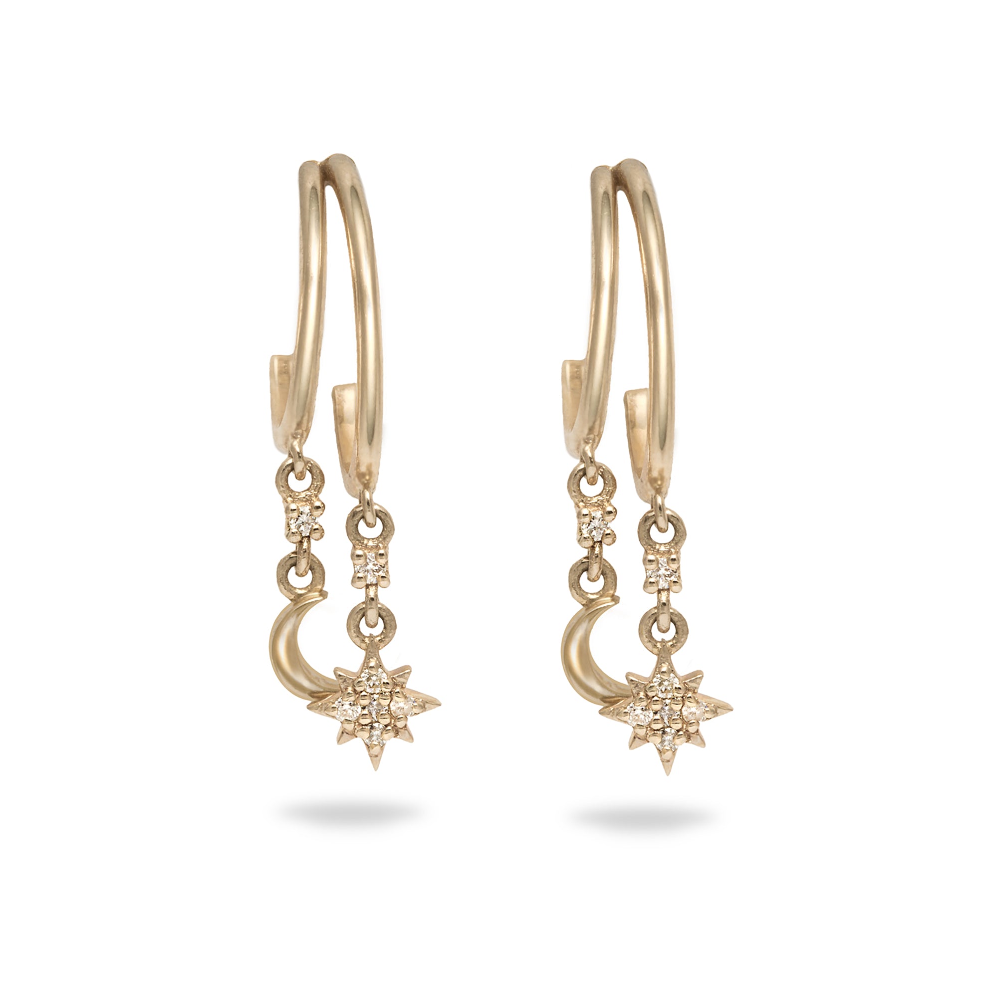 Gold earrings with star and moon designs on a white background