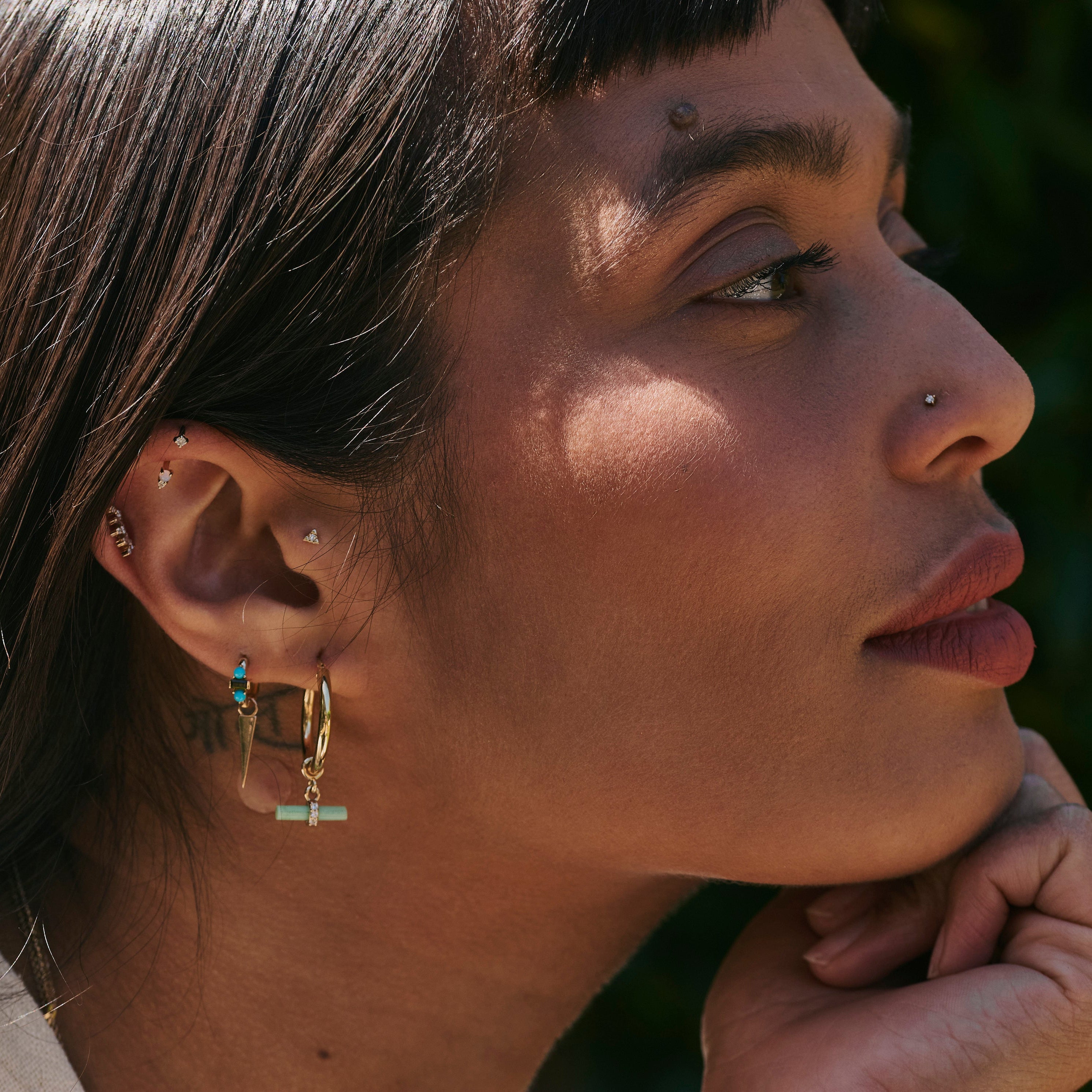model wearing the Chrysoprase T-Bar Hoop Earrings 9k Gold and other solid gold earrings