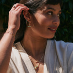 model wearing solid gold jewellery including the Chrysoprase T-Bar Hoop Earrings 9k Gold
