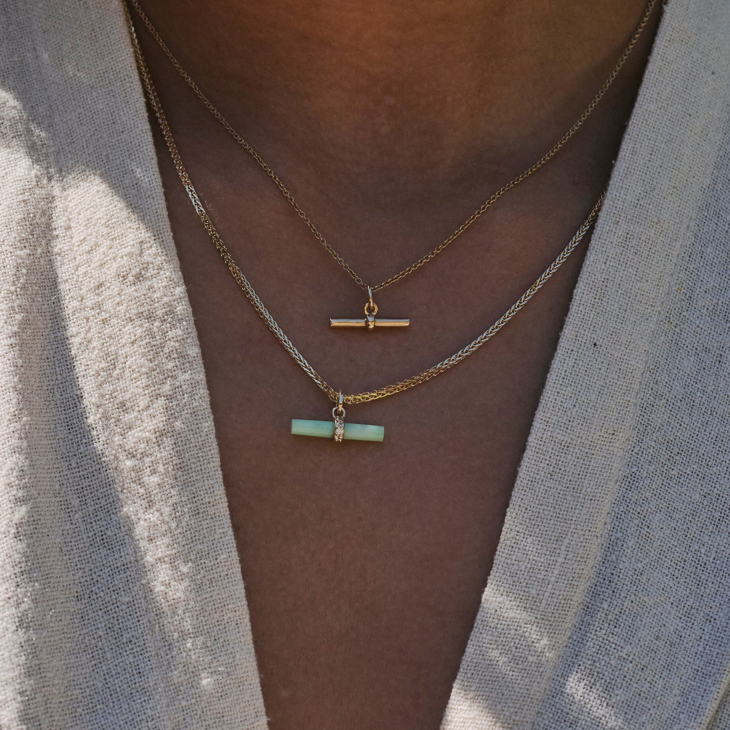 model wearing t-bars layered including the Chrysoprase T-Bar Pendant 9k Gold