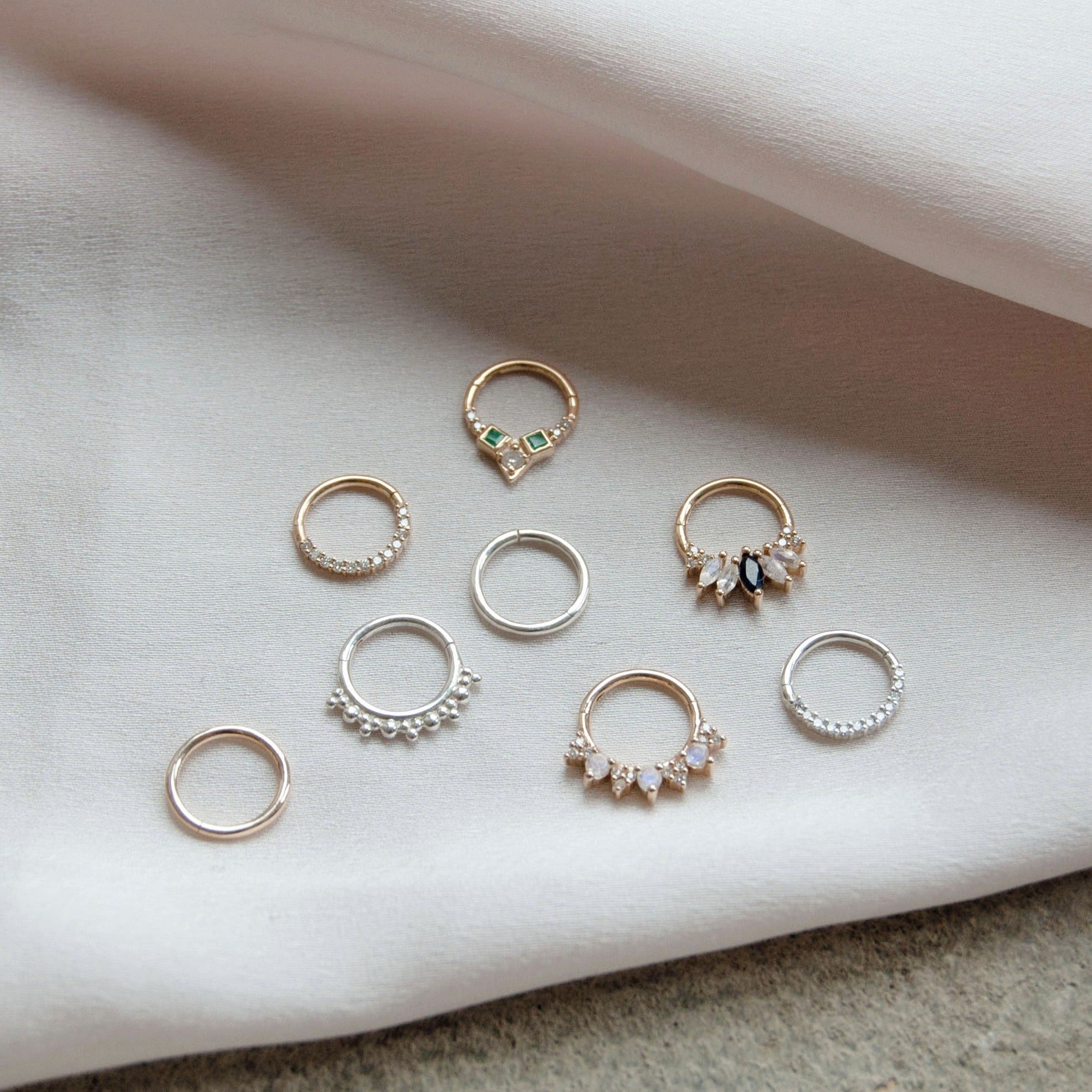 seven different daith earrings in sterling silver and solid 9k gold