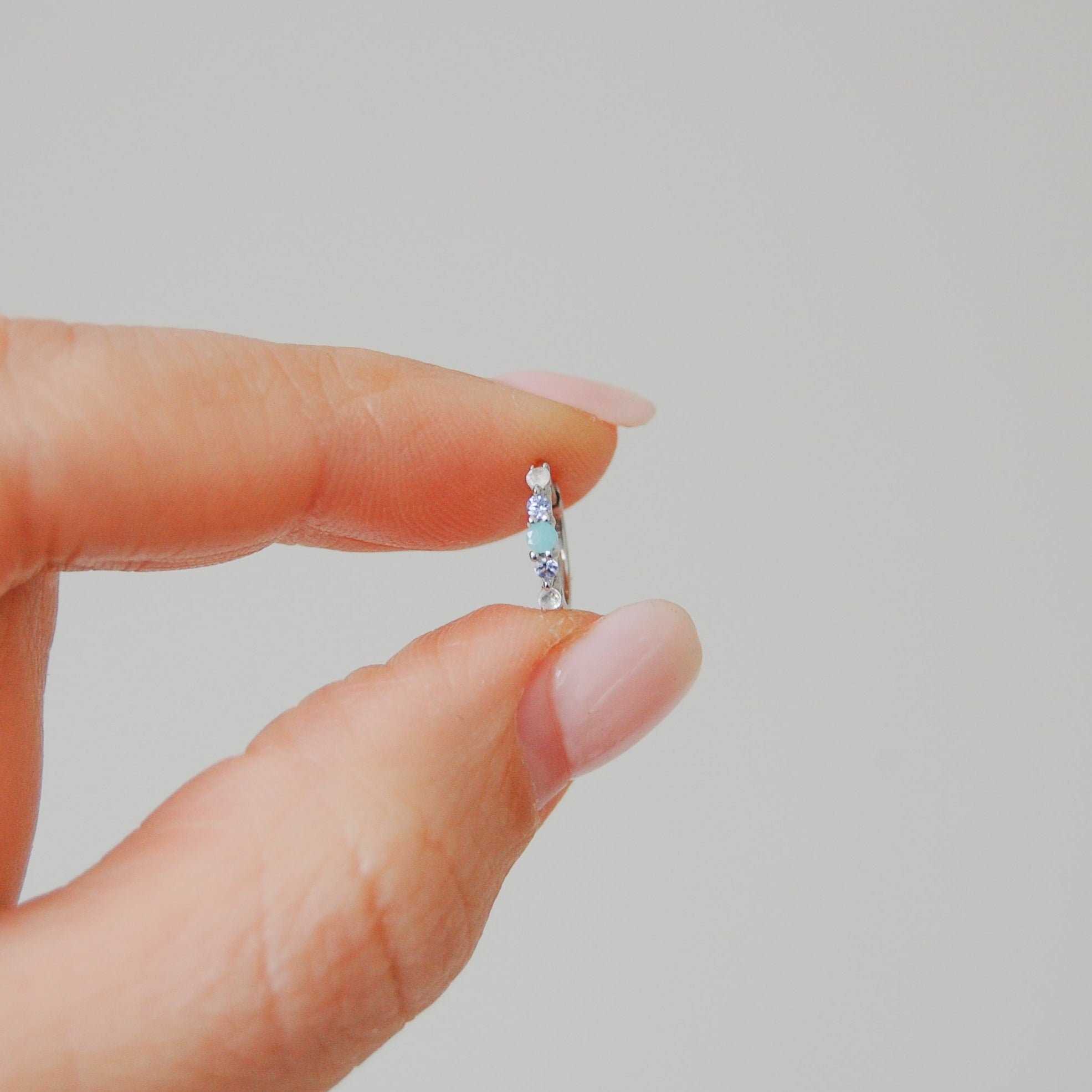 hand holding the Amazonite, Tanzanite & Moonstone Huggie Hoop Earring Sterling Silver