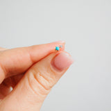 hand model holding the Turquoise & Diamond Flat Back Earring 9k Gold