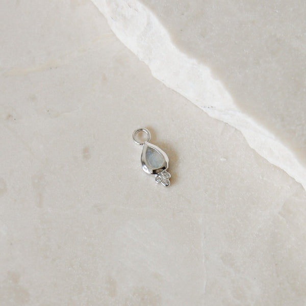 Moonstone & White Sapphire Tear Drop Earring Charm Sterling Silver on marble surface