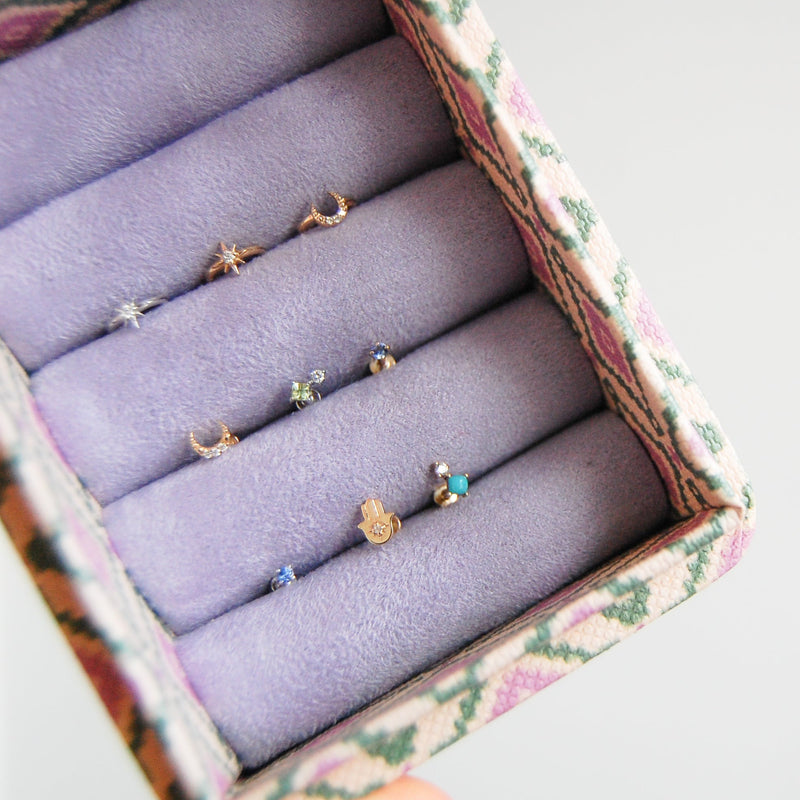 earring display in purple and green jewellery box including the Diamond Moon Seamless Huggie Hoop Earring 9k Gold