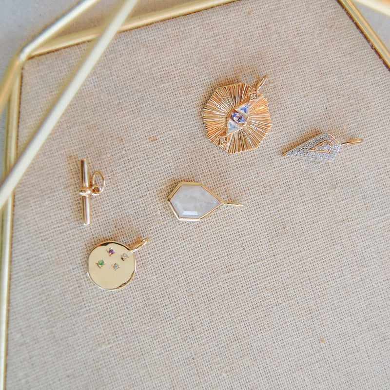 gold pendants in jewellery tray  including the Multi Semi-Precious Organic Coin Pendant 9k Gold