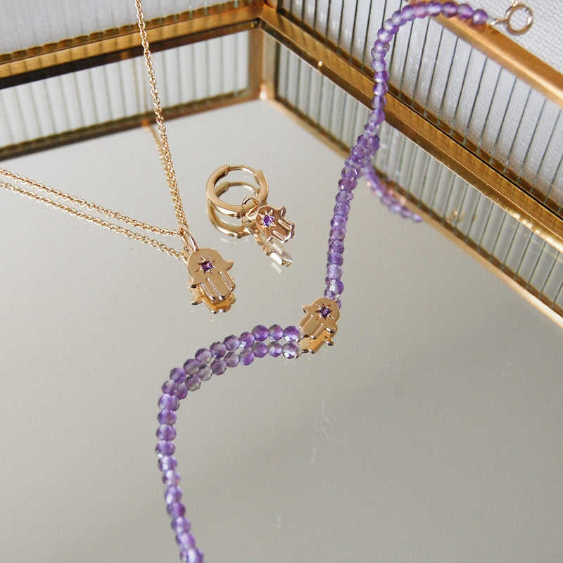solid gold amethyst hand of fatima pendant, hoop and bracelet in mirror jewellery box
