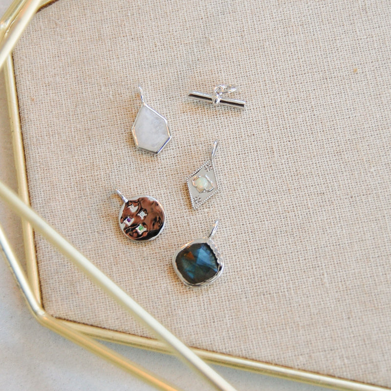 sterling silver pendant collection in fabric tray including the Grecian Labradorite Stone Pendant Sterling Silver