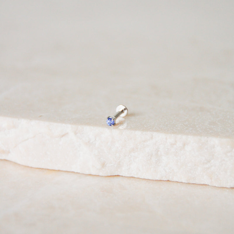 Mini Tanzanite Solitaire Flat Back Earring 14k White Gold on marble surface