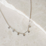 Mini Coin Necklace Sterling Silver on marble surface