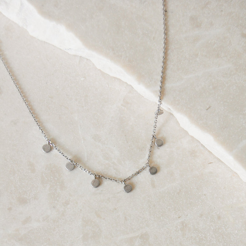 Mini Coin Necklace Sterling Silver on marble surface