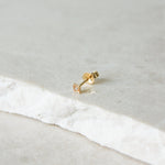 Diamond Star Stud Earring 9k Gold on marble surface