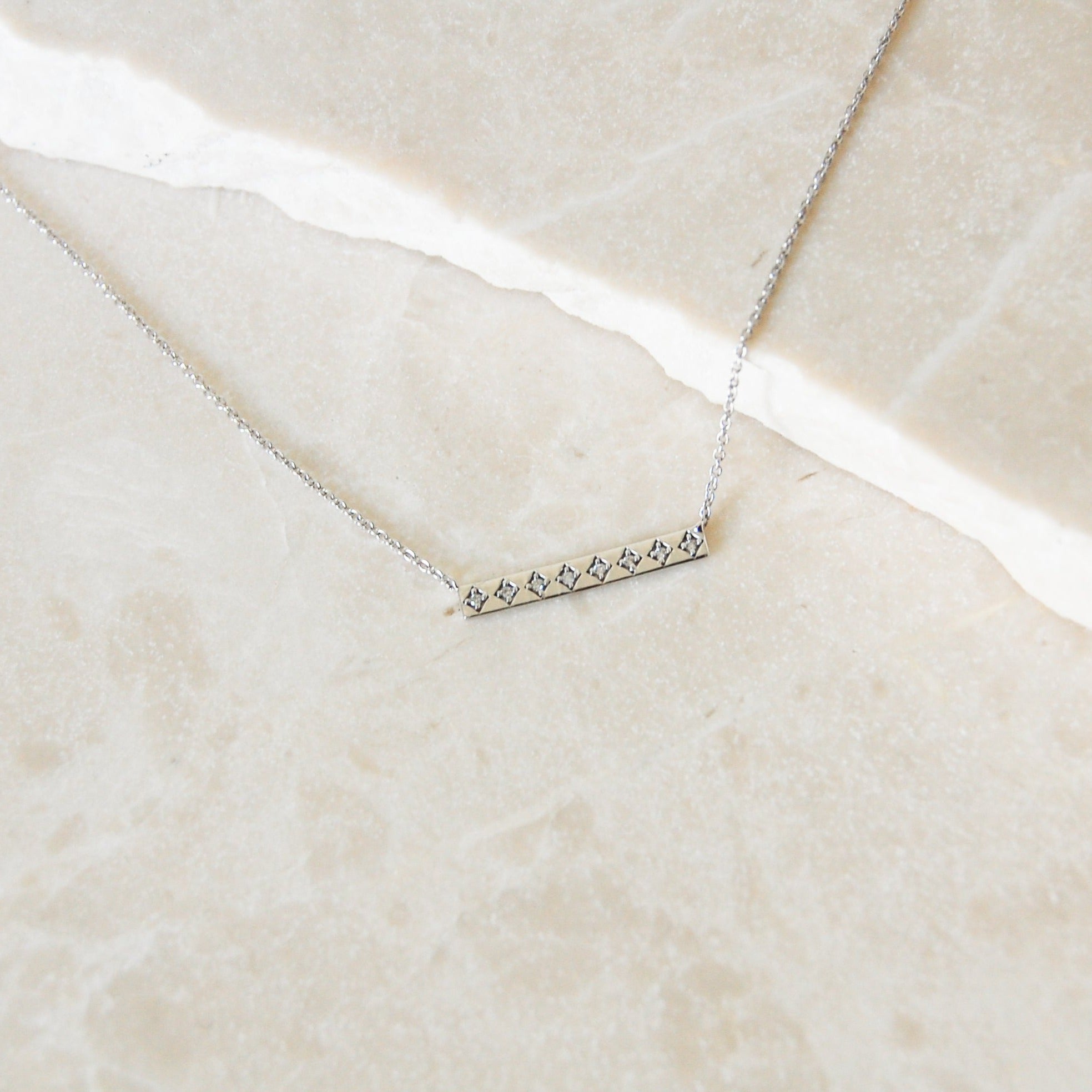 Diamond Bar Necklace 9k White Gold on marble surface