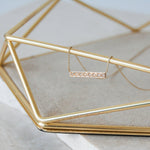 Diamond Bar Necklace 9k Gold hanging from jewellery box bar