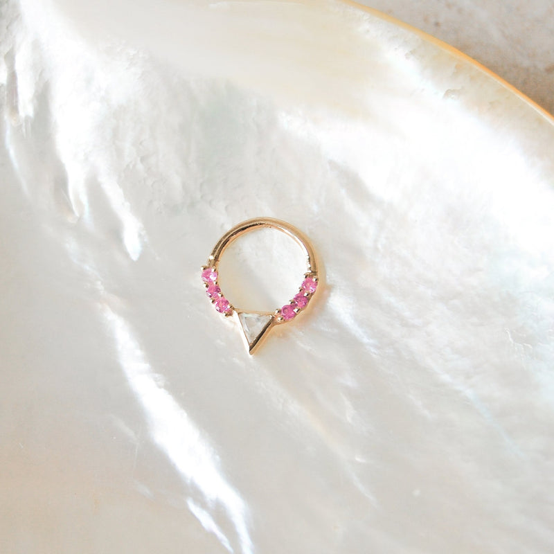 moonstone & pink sapphire hoop made of 9k solid gold for daith piercings displayed on a white textured background