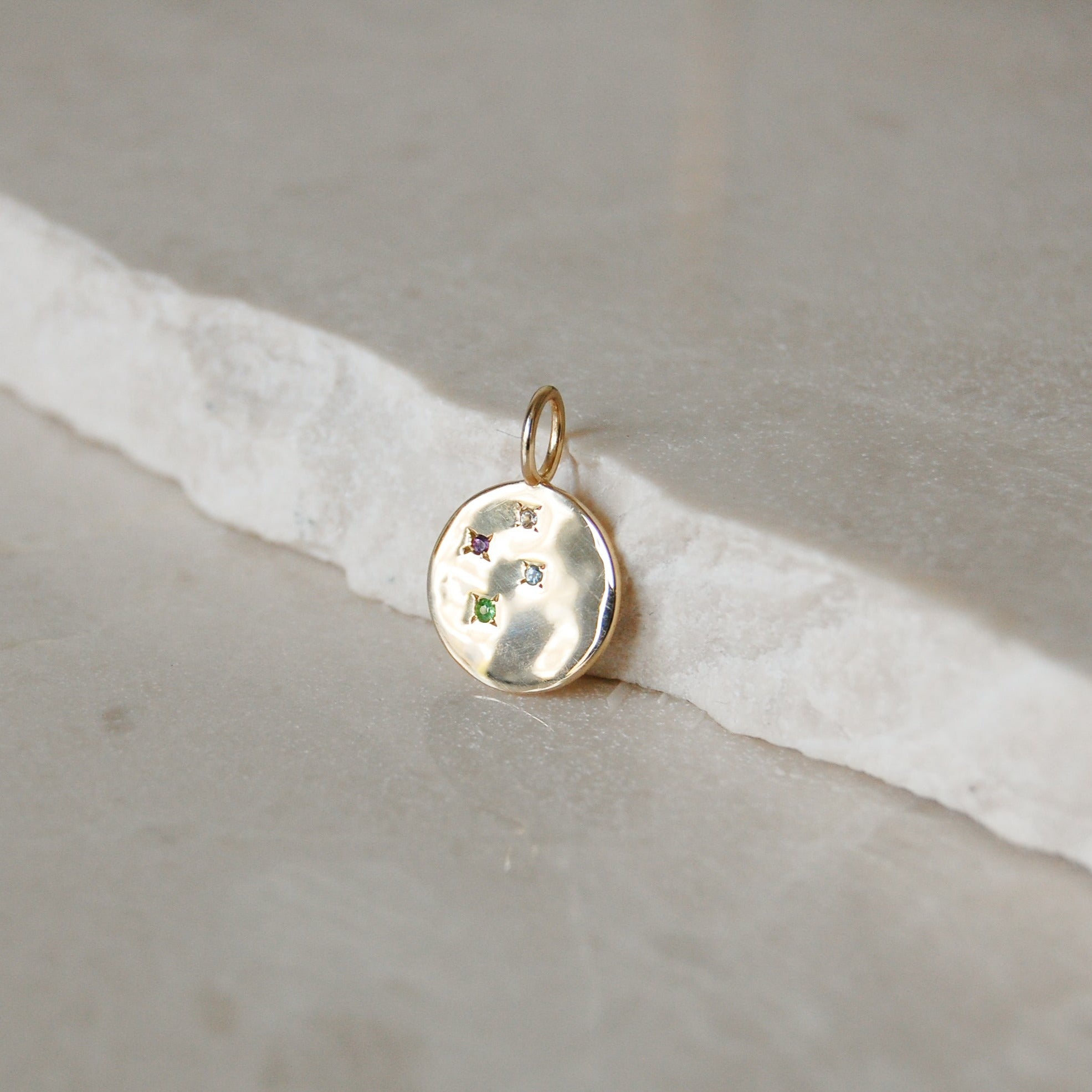 Multi Semi-Precious Organic Coin Pendant 9k Gold on marble surface