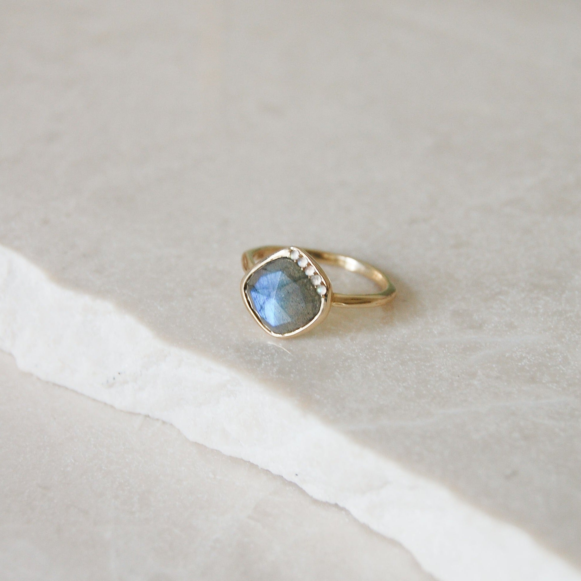 Grecian Labradorite Stone Ring 9k Gold on marble surface