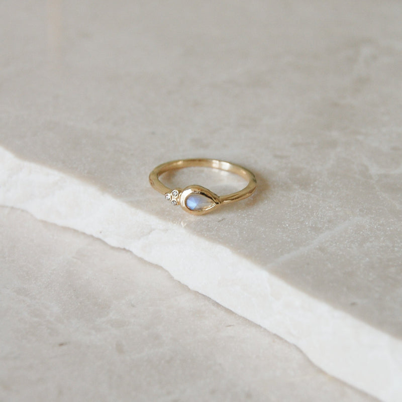 Moonstone & Diamond Tear Drop Ring 9k Gold on  marble surface