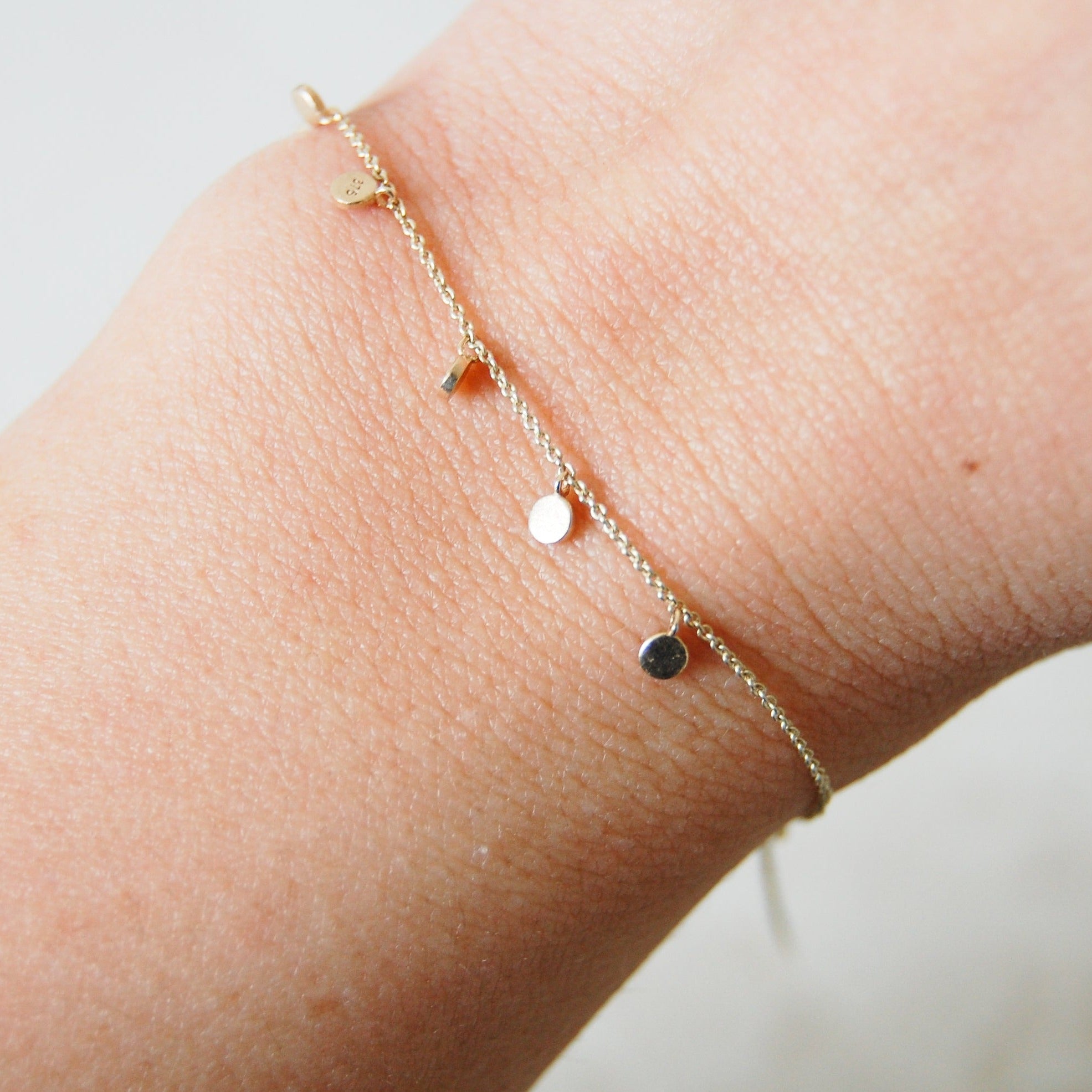 Mini Coin Bracelet 9k Gold on model wrist