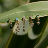 Diamond Drop Spike Earring Charm 9k Gold displayed from a green leaf along with other solid gold earrings and charms