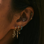model wearing solid gold earrings and charms including the Diamond Drop Spike Earring Charm 9k Gold