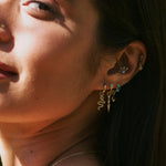 model wearing solid gold ear stack including the Diamond Drop Spike Earring Charm 9k Gold