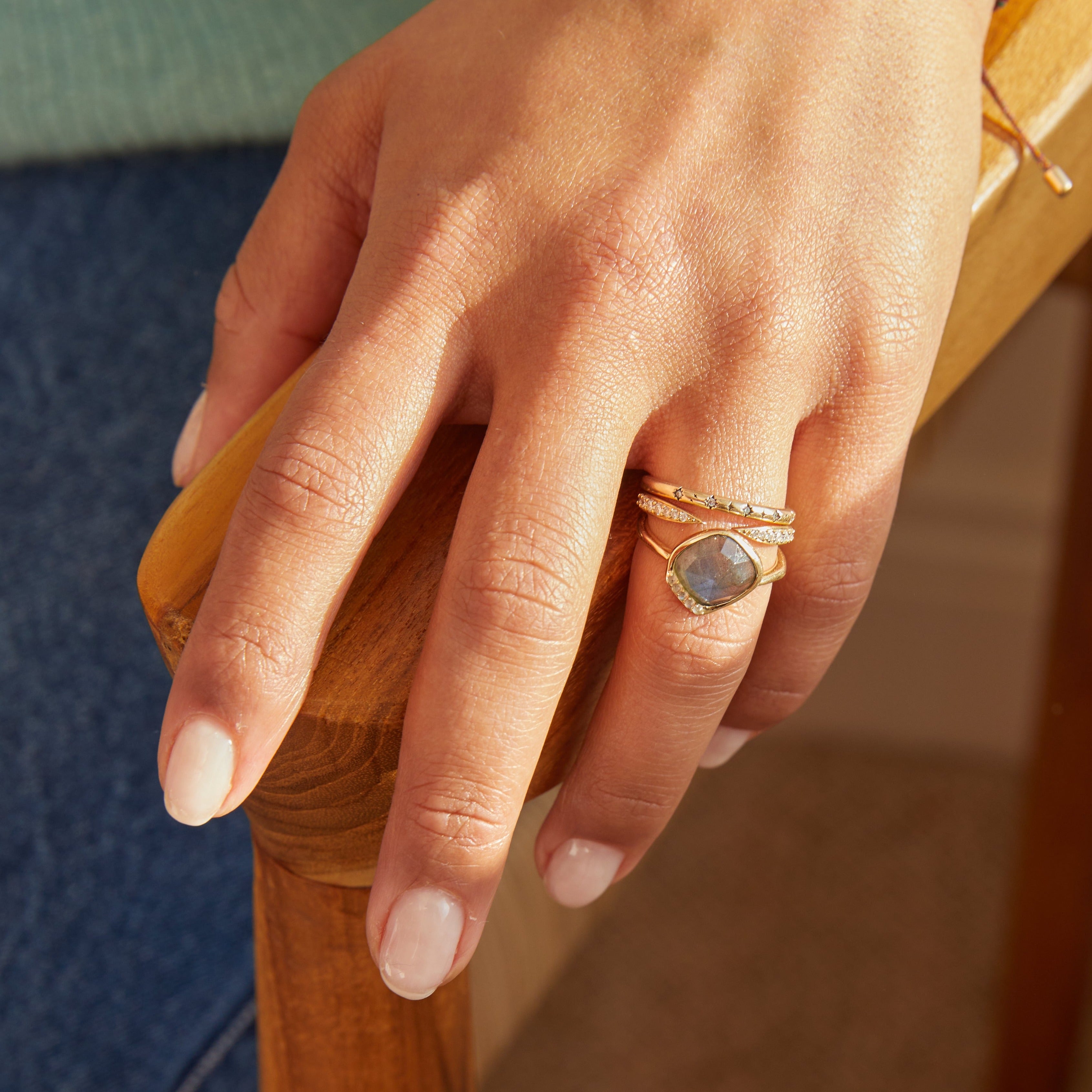 model wearing solid gold rings including the diamond open ring 9k gold