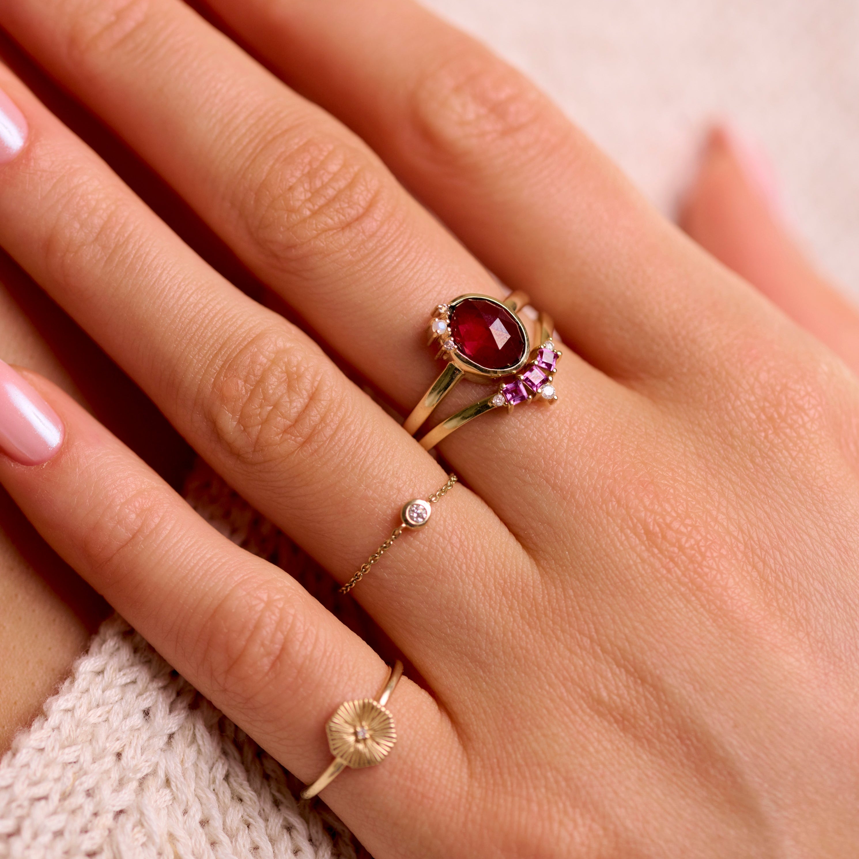 model wearing solid gold rings including the Diamond Solitaire Chain Ring 9k Gold
