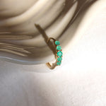 Emerald Huggie Earring 9k Gold on porcelain dish