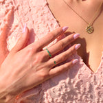 emerald rings on model in pink dress