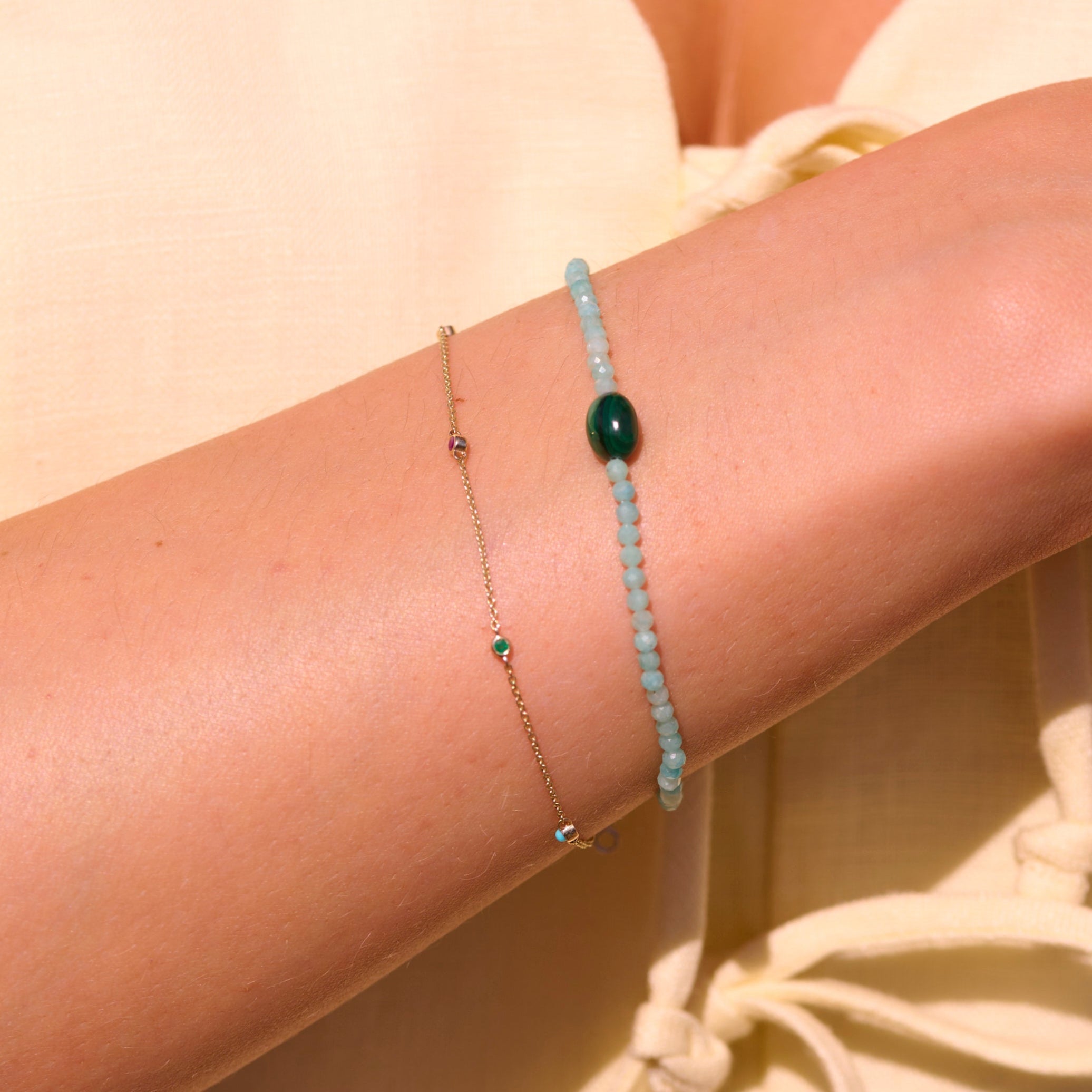 model wearing beaded and chain bracelets including the Gem Stone Station Bracelet 9k Gold