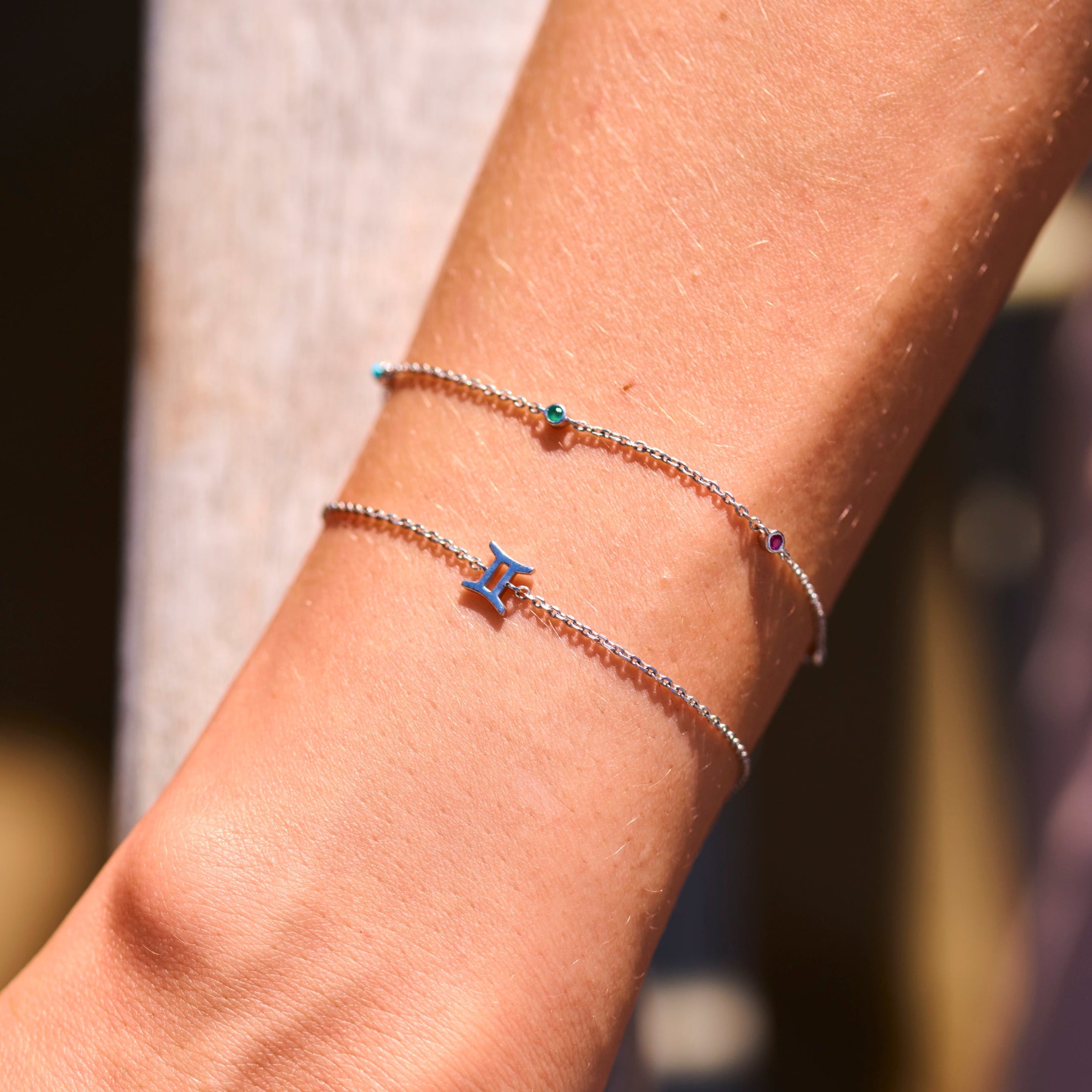 model wearing sterling silver bracelets including the Gem Stone Station Bracelet Sterling Silver
