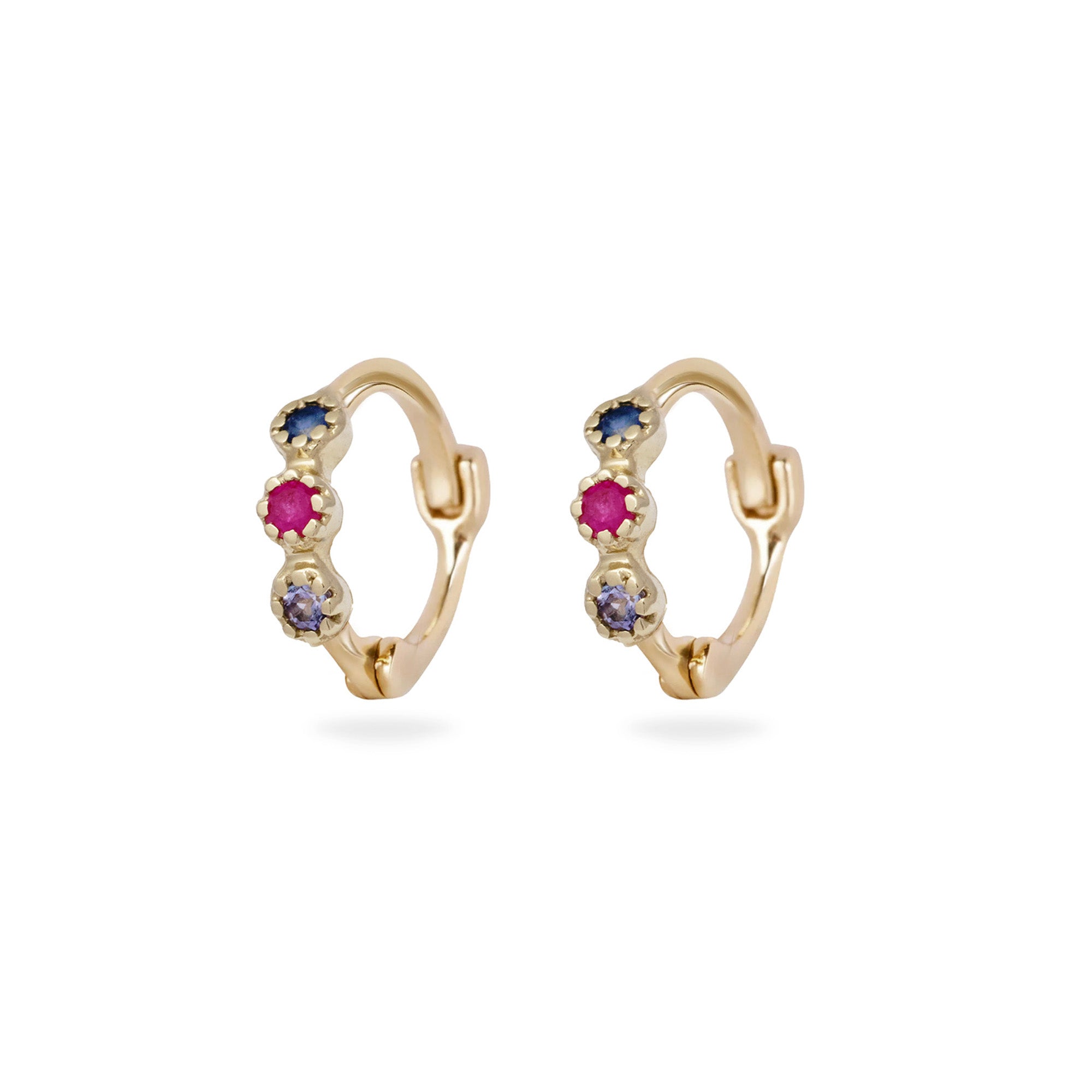 Gold hoop earrings with gemstones on a white background