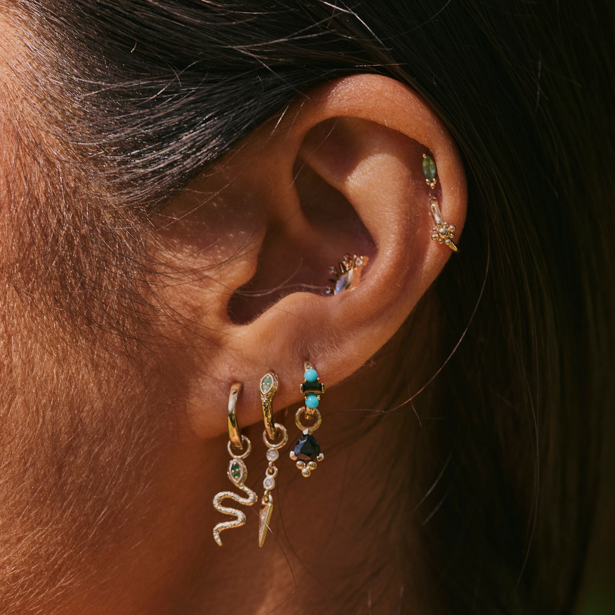 solid gold ear stack including the Green Tourmaline & Turquoise Huggie Hoop Earring 9k Gold