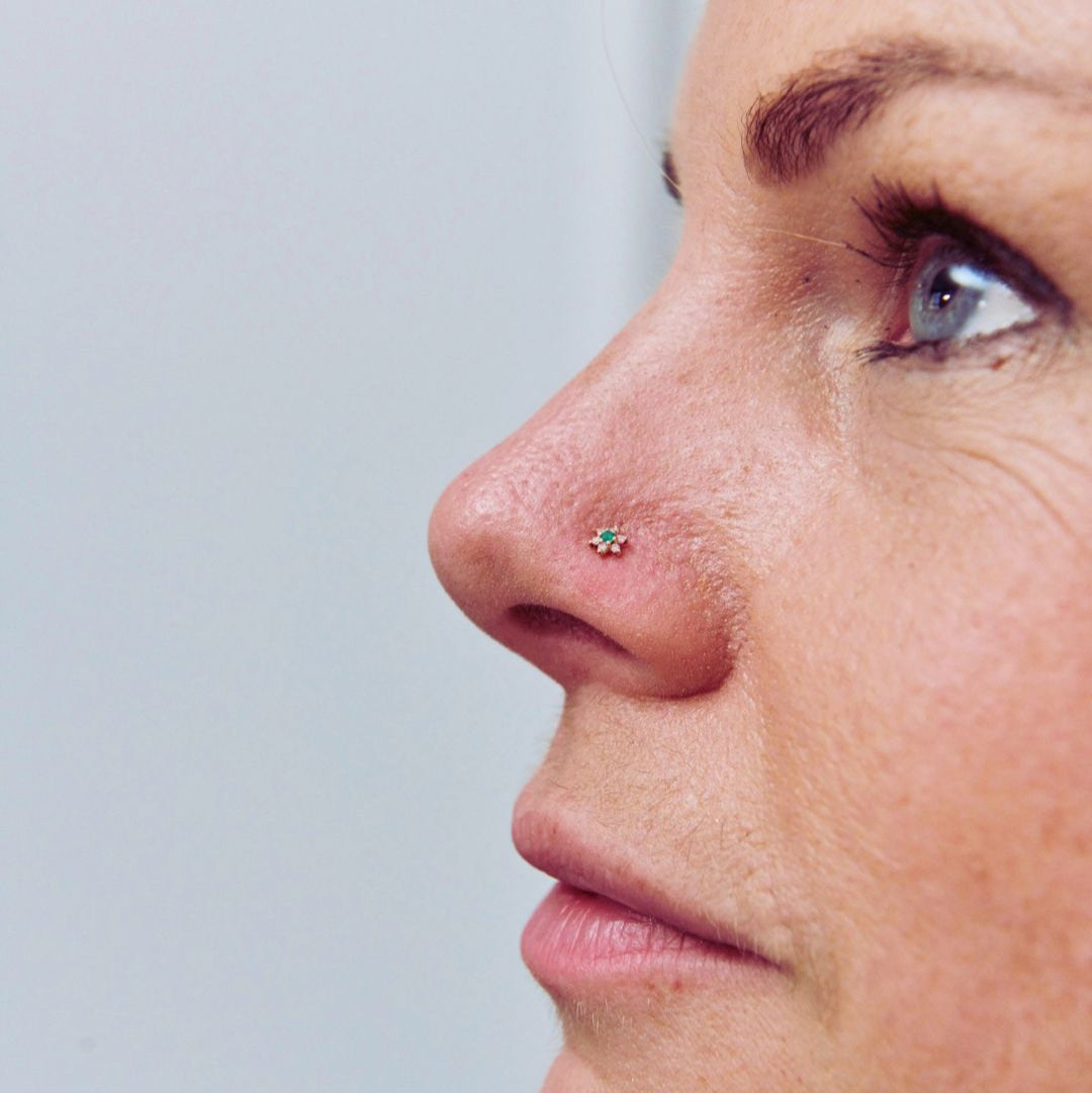 nose stud worn with plain background