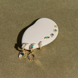 Set of earrings on a white stone with a greenish background