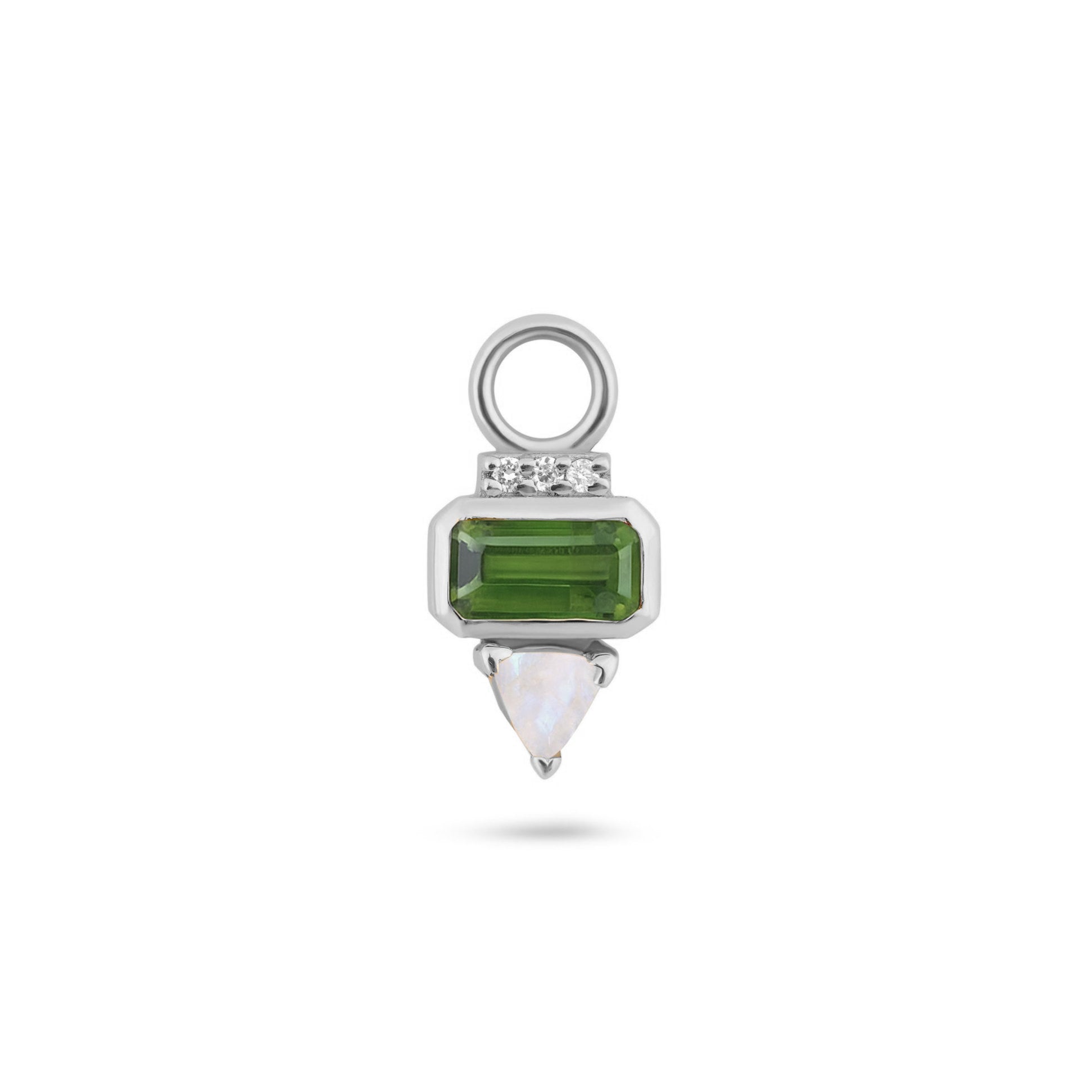 Silver charm with green gemstone and white stone on a white background