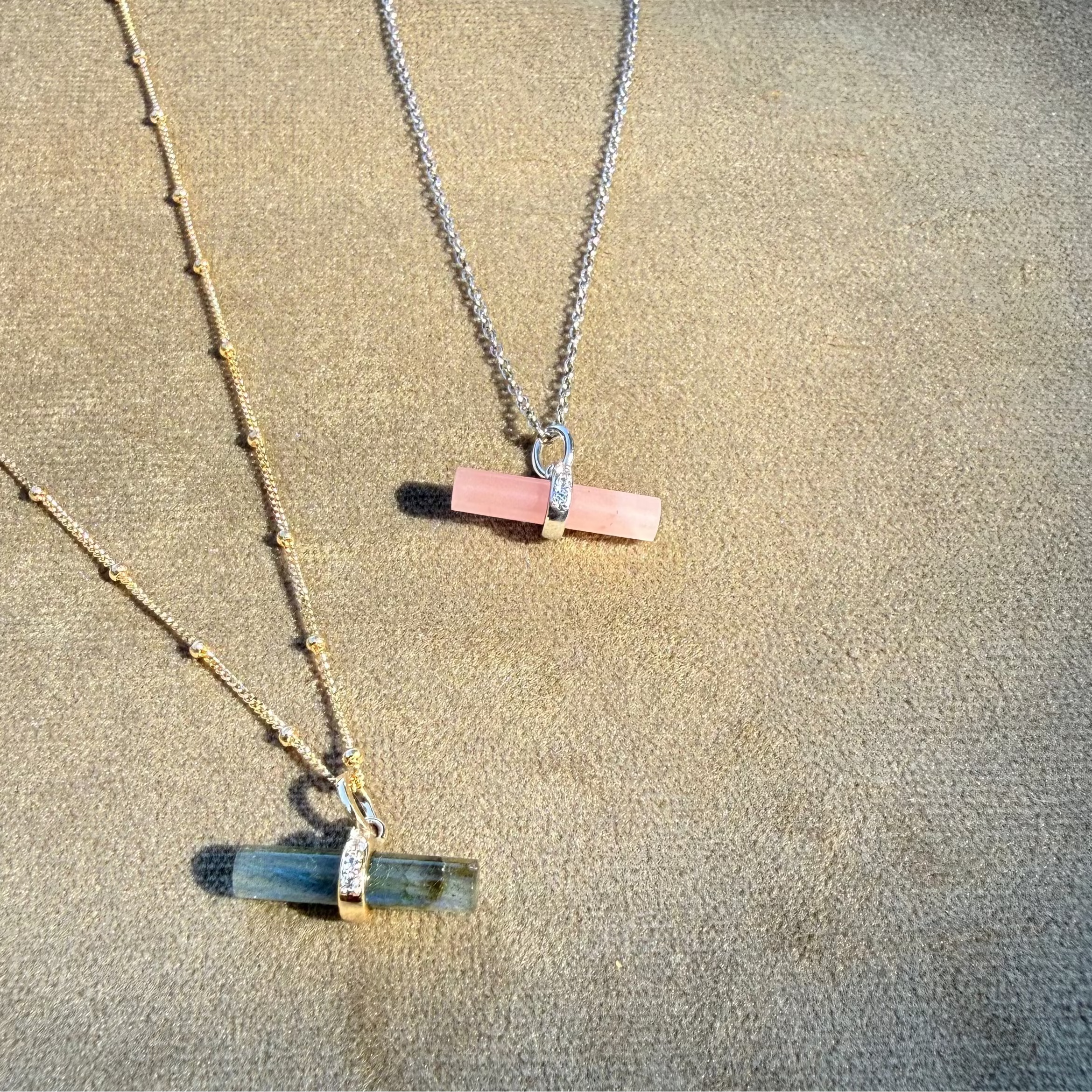 Guava Quartz T-Bar Pendant Sterling Silver displayed on soft fabric along with the labradorite t-bar