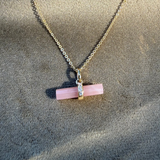 Guava Quartz T-Bar Pendant 9k Gold on soft fabric