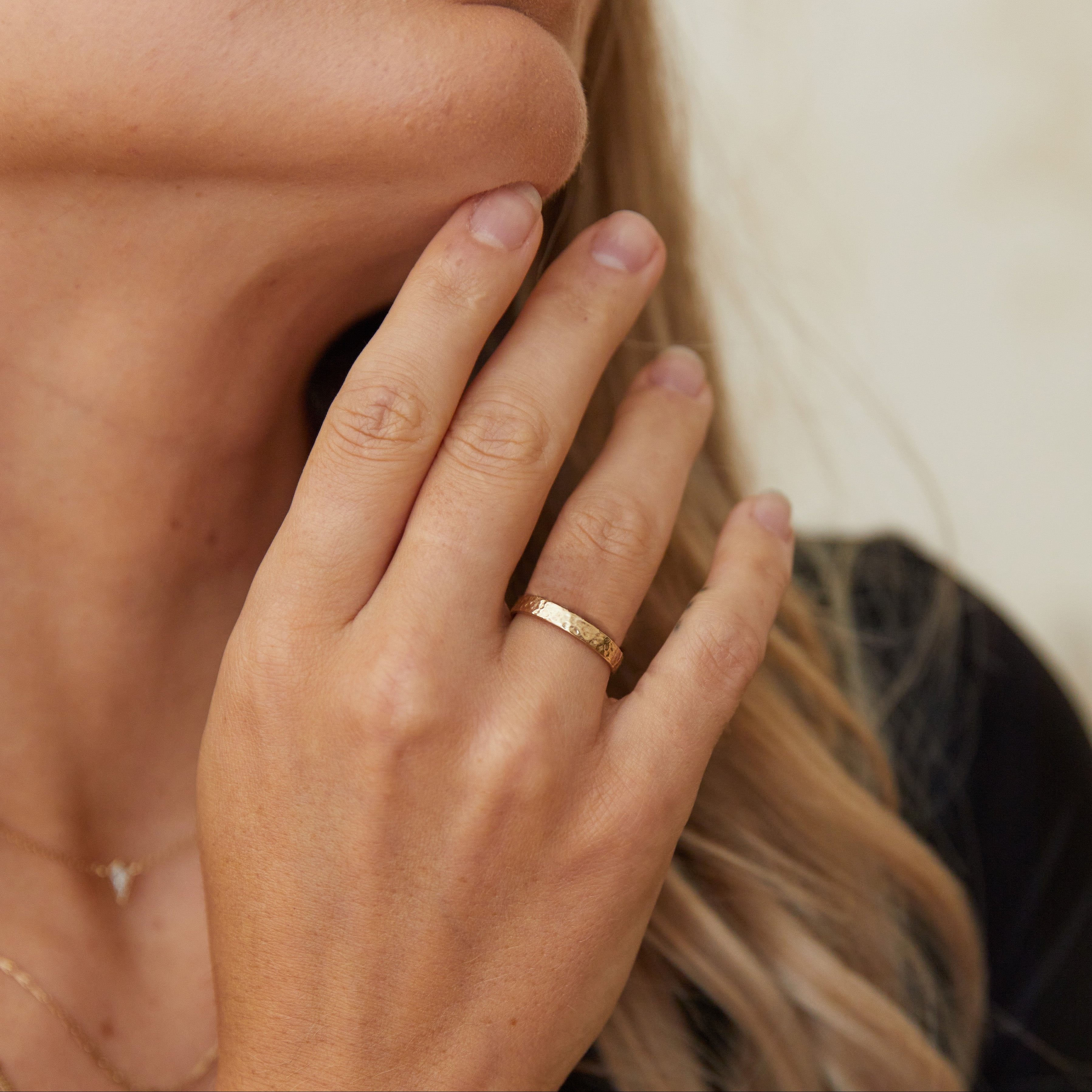 GOLD RING ON FINGER