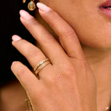 model wearing 2 slid gold rings one of them the Hammered Band Ring 9k Gold