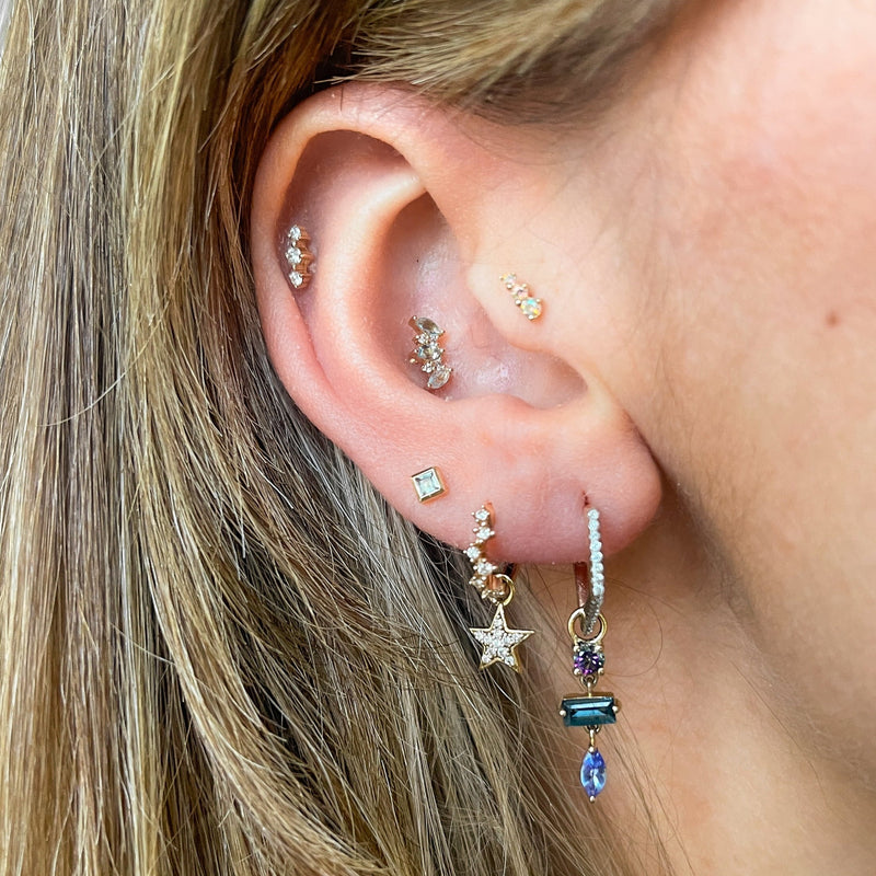 model wearing gold earring stack including the Aquamarine & Diamond Flat Back Earring 14k Gold