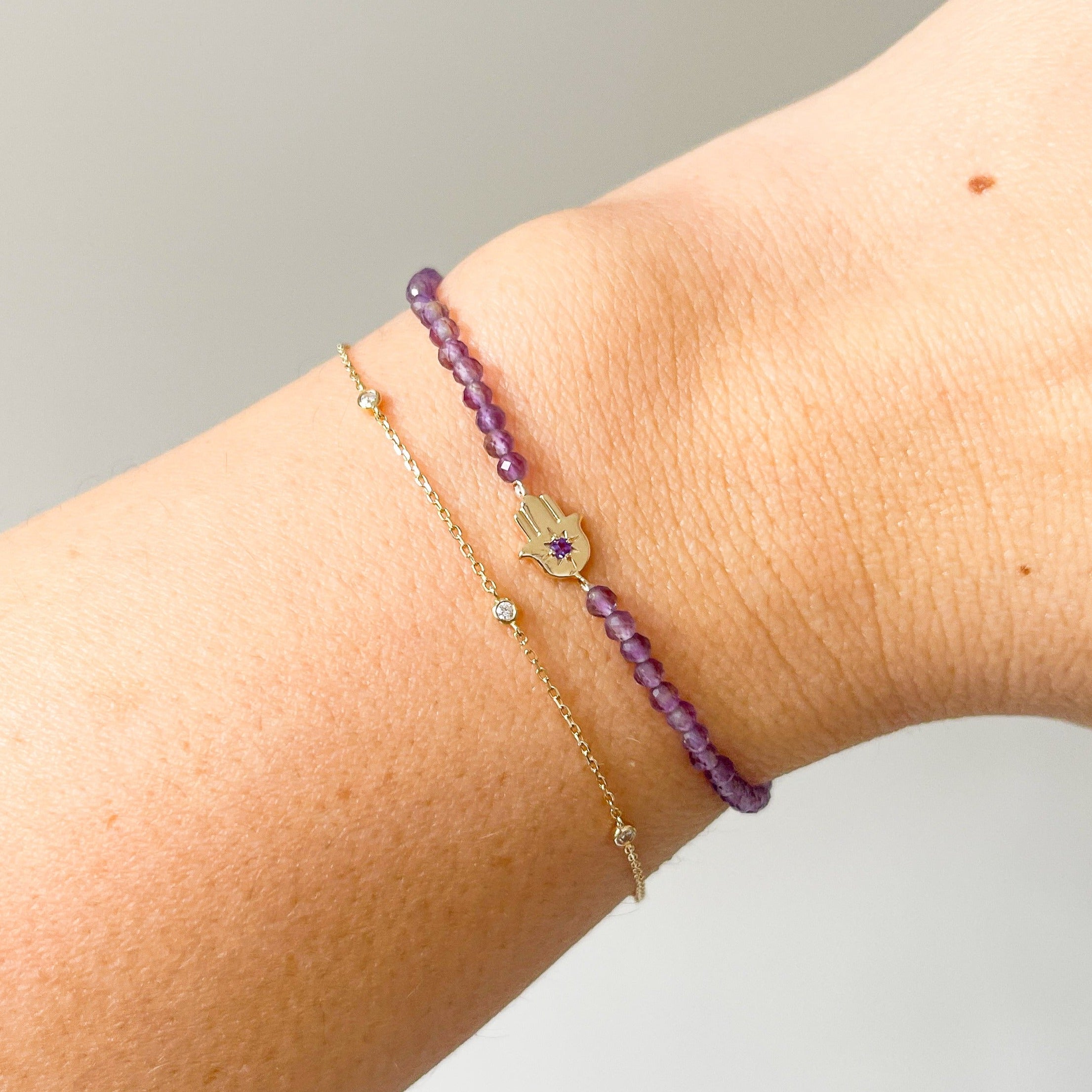 model wrist showing the hand of fatima amethyst beaded bracelet 9k gold and diamond bracelet