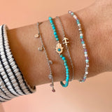 model wearing silver bracelets including the Hand of Fatima Turquoise Beaded Bracelet Sterling Silver