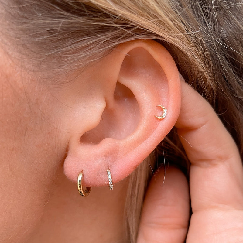 model wearing gold earrings and Diamond Moon Flat Back Earring 9k Gold on helix