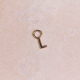 Initial Earring Charm 9k Gold on hard surface