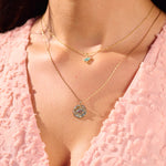 close up of model solid gold necklaces including the Labradorite & Diamond Eye Coin Necklace 9k Gold
